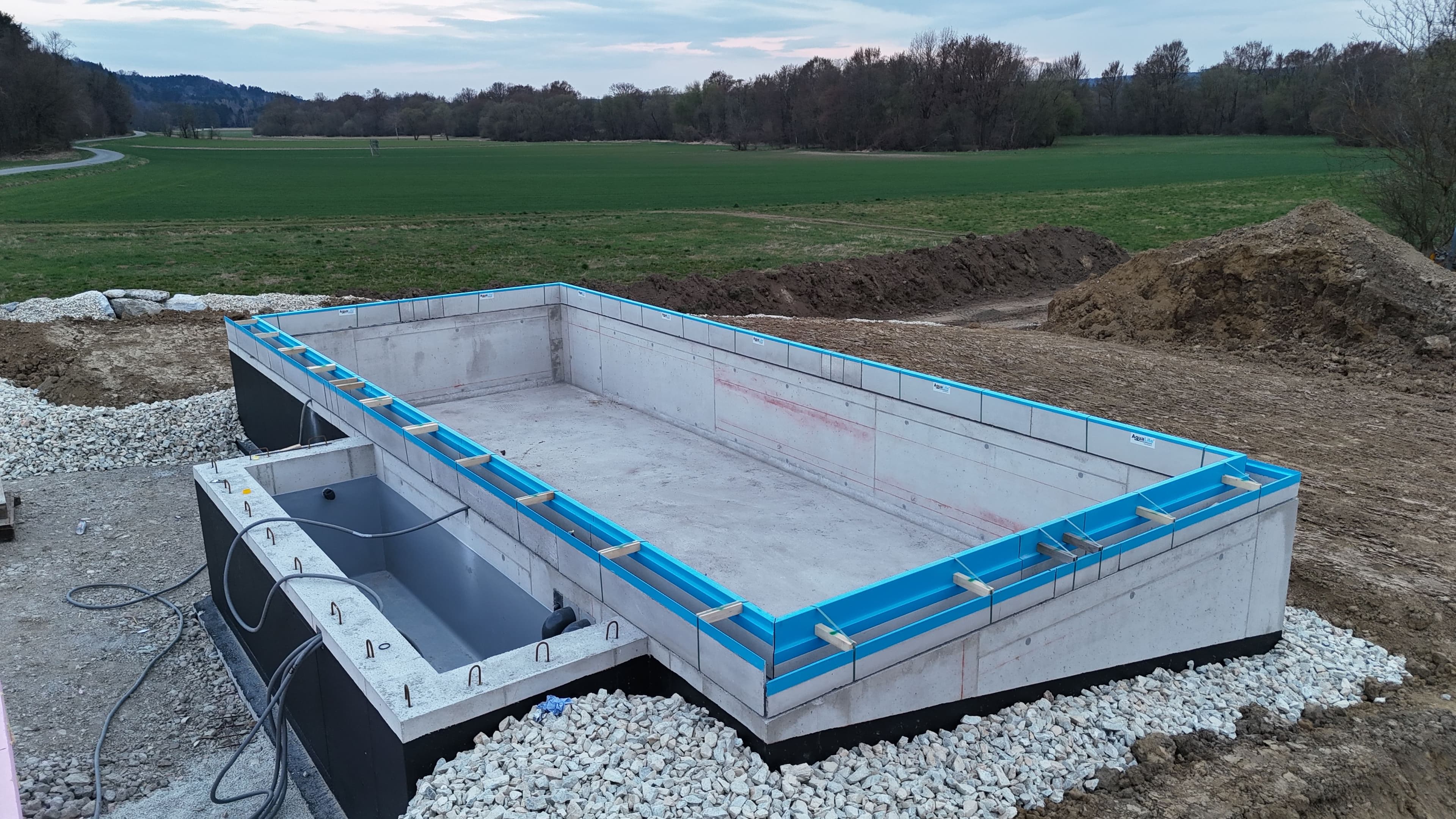 AquaLite-Rinnenelemente werden auf einem Rohbau-Poolbecken montiert